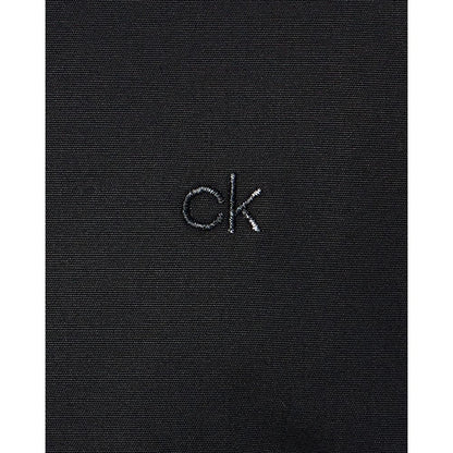 Close-up of Calvin Klein Black Cotton Dress Shirt fabric with 'ck' logo embroidered.