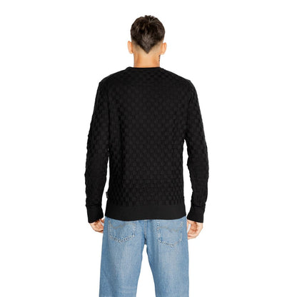 Back view of Calvin Klein Black Organic Cotton Sweatshirt with basket weave pattern, model K10K113747, worn by a man in jeans.