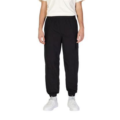 Calvin Klein Jeans Black Cotton Joggers (Workout Pants) showcased on a model, featuring a comfortable fit with practical utility pockets and elastic waistband.
