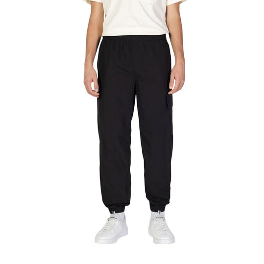 Calvin Klein Jeans Black Cotton Joggers (Workout Pants) showcased on a model, featuring a comfortable fit with practical utility pockets and elastic waistband.
