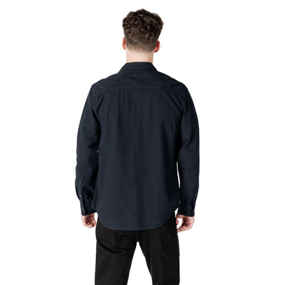 Back view of model wearing Calvin Klein Jeans Black Cotton Shirt, a long-sleeve regular fit essential for men's wardrobe.