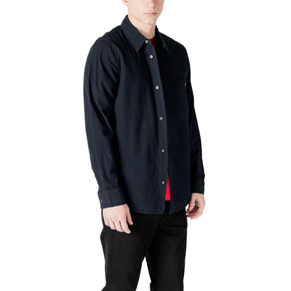 Man wearing Calvin Klein Jeans Black Cotton Shirt with long sleeves and chest pocket, perfect for casual wear.