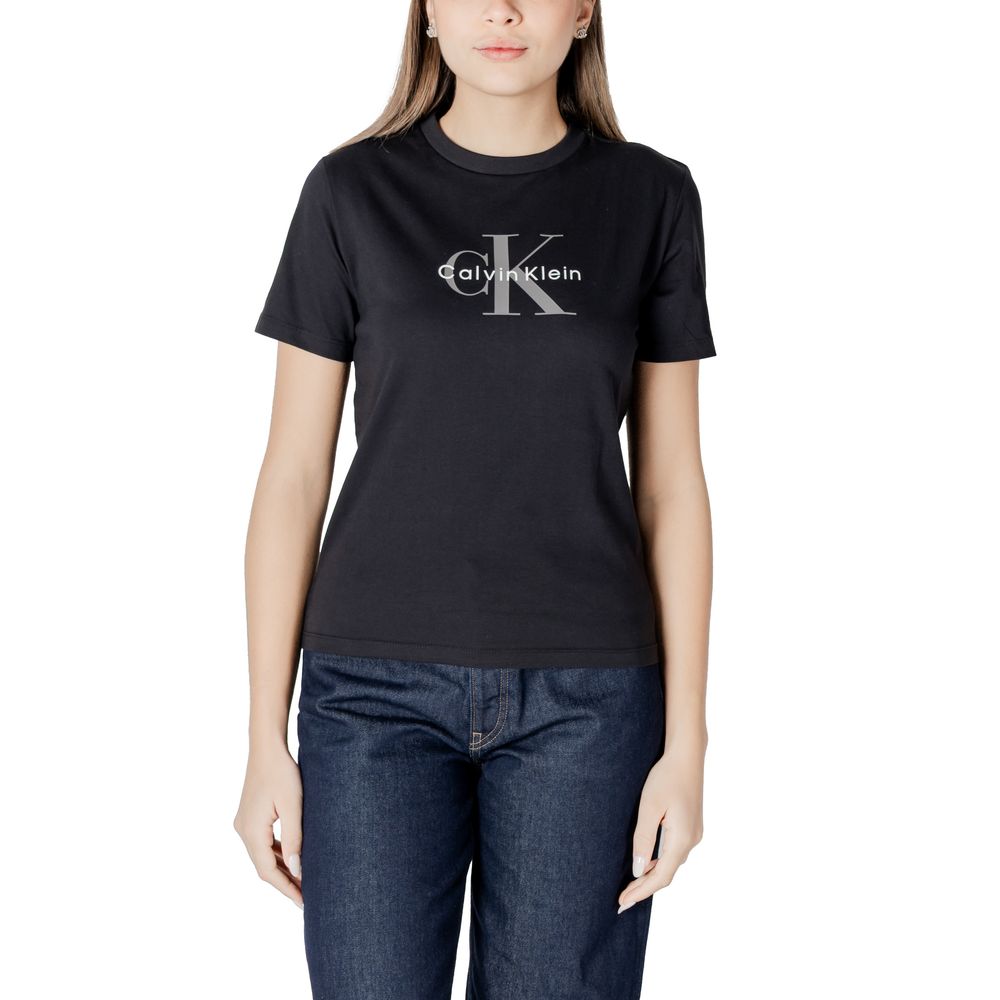 Woman wearing Calvin Klein Jeans Black Cotton T-Shirt with logo, styled with blue jeans, perfect for casual spring and summer fashion.