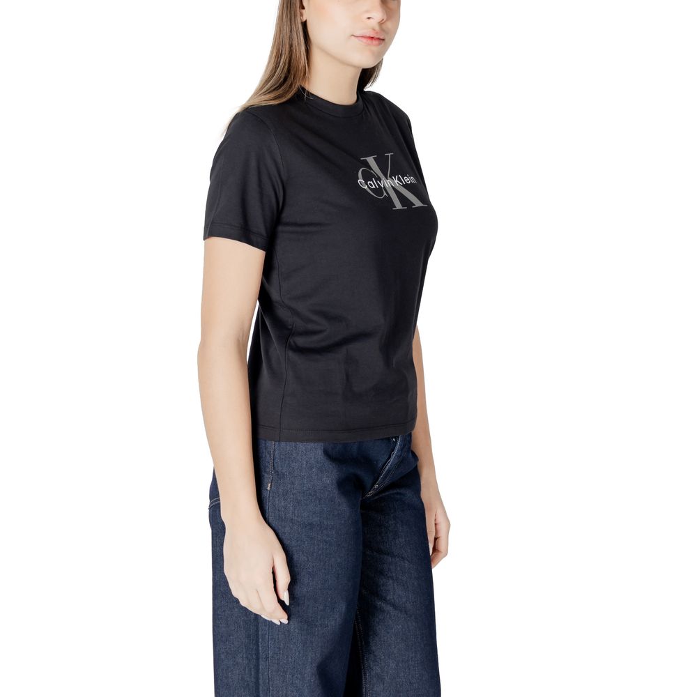 Woman wearing Calvin Klein Jeans Black Cotton T-Shirt with brand logo, paired with denim jeans for a casual chic style.