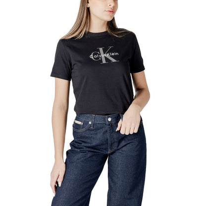 Woman wearing Calvin Klein Jeans Black Cotton T-Shirt with logo, paired with blue jeans, showcasing casual chic fashion.