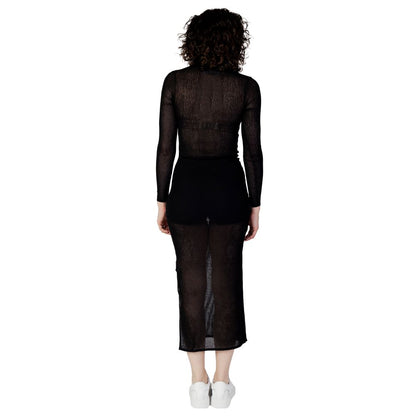 Back view of model wearing Calvin Klein Jeans Black Marabou Long Dress, showcasing sheer fabric and elegant silhouette.