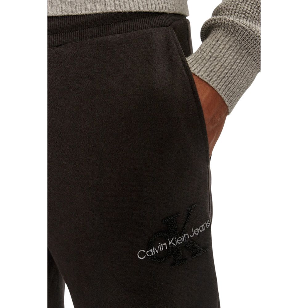 Close-up of Calvin Klein Jeans Black Organic Cotton Joggers with logo, showcasing comfortable fit and modern style for daily activities.