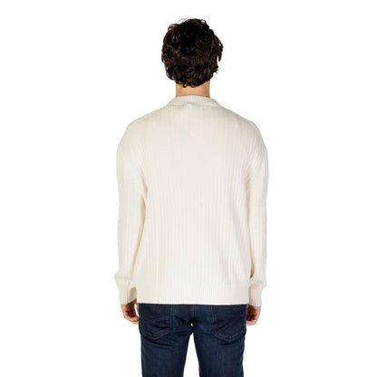 Back view of a model wearing Calvin Klein Jeans Cream Cotton Sweatshirt with vertical ribbed texture and crew neck.
