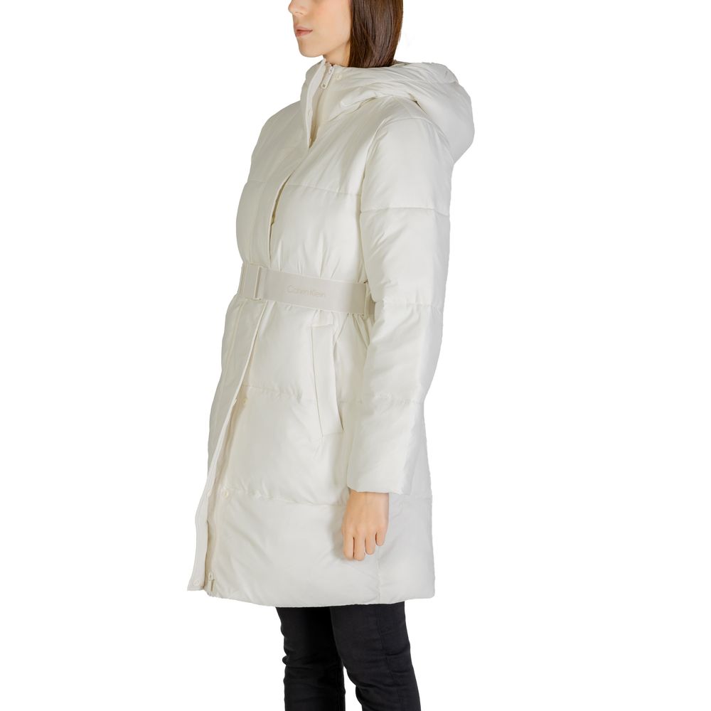 Woman wearing Calvin Klein Jeans Cream Nylon Coat with logo belt, side view of long puffer jacket.