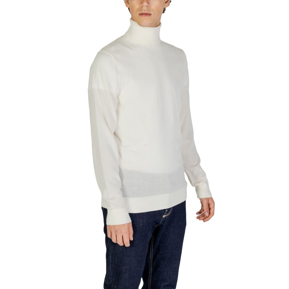 Man wearing Calvin Klein Jeans Cream Wool Turtleneck, showcasing its minimalist design and cozy warmth for winter fashion.