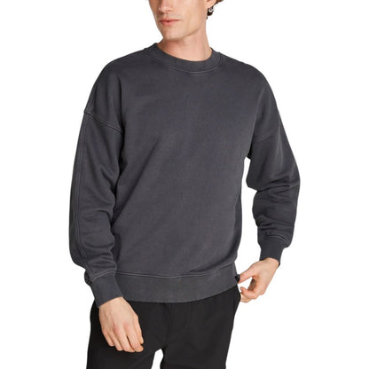 Model wearing Calvin Klein Jeans Gray Cotton Sweatshirt with wide sleeves and comfortable fit, made from 80% cotton and 20% recycled cotton.