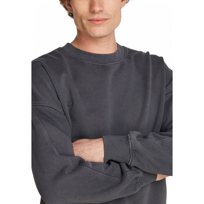 Man wearing Calvin Klein Jeans Gray Cotton Sweatshirt with wide sleeves and comfortable fit, showcasing style and comfort.