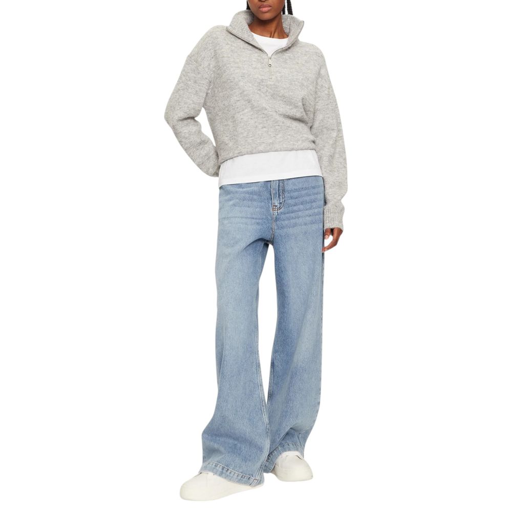 Model wearing Calvin Klein Jeans Gray Polyester Cardigan with half-zip design, paired with light blue jeans, showcasing elegance and comfort.