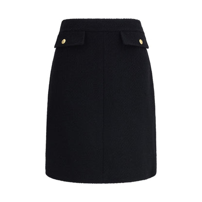 Chloé Black Wool Midi Skirt with bouclé texture and gold-tone buttons, features front flap pockets and side zip for a sleek fit.