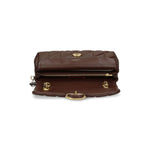 Open view of Coach Tabby 26 Shoulder Bag in chestnut brown quilted leather with gold C plaque and zip fastening pocket.