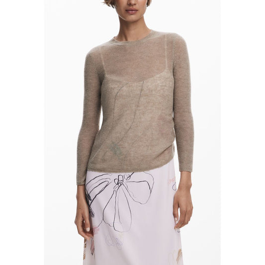 Woman in a beige long-sleeve top with a floral print skirt, showcasing casual elegance.