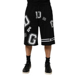 Model wearing Dolce & Gabbana Black Logo Print Cotton Casual Bermuda Short with stylish logo print and drawstring closure.