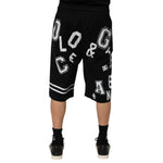 Rear view of Dolce & Gabbana Black Logo Print Cotton Casual Bermuda Short with white logo, model wearing casual black footwear