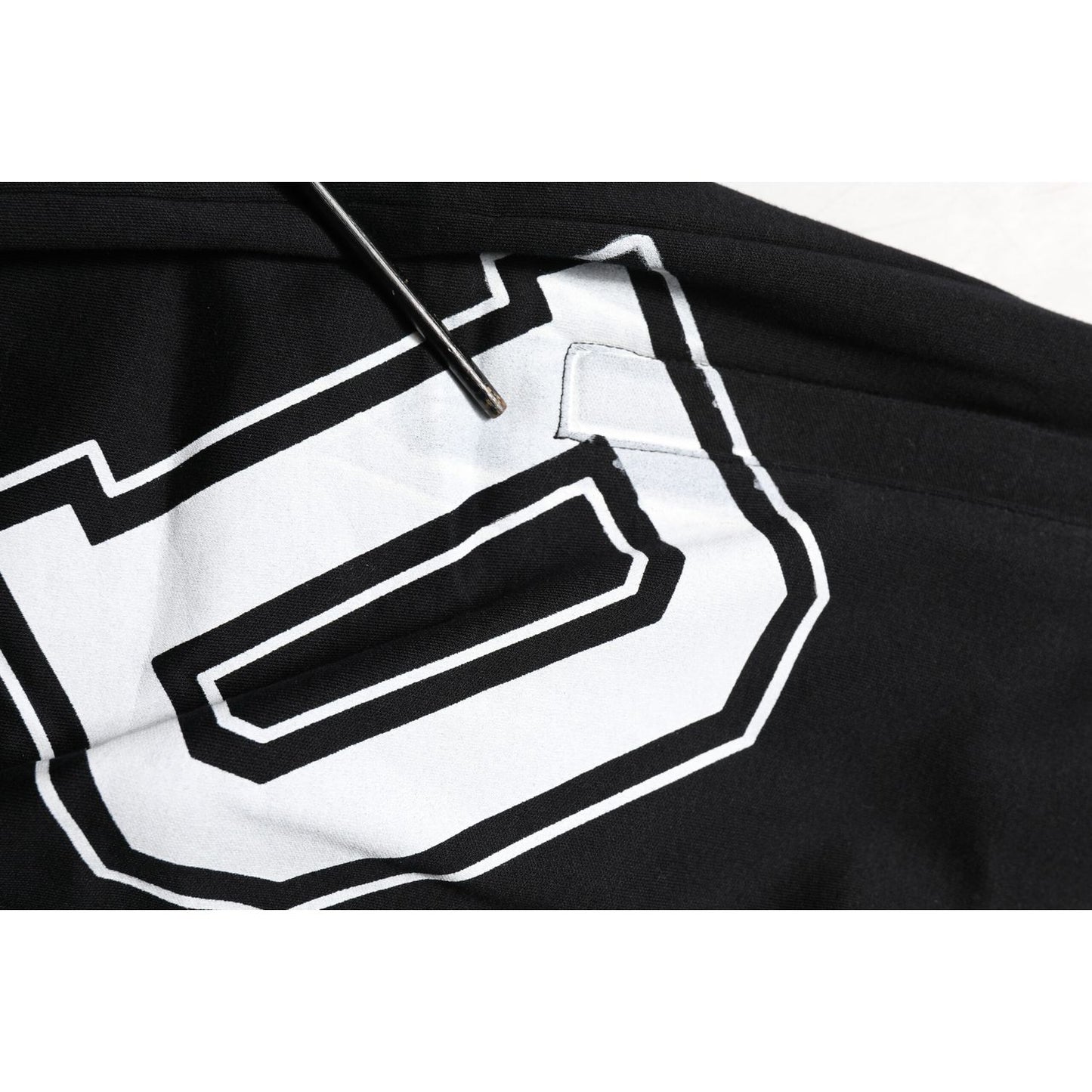 Close-up of Dolce & Gabbana Black Logo Print Cotton Casual Bermuda Short with white logo detail