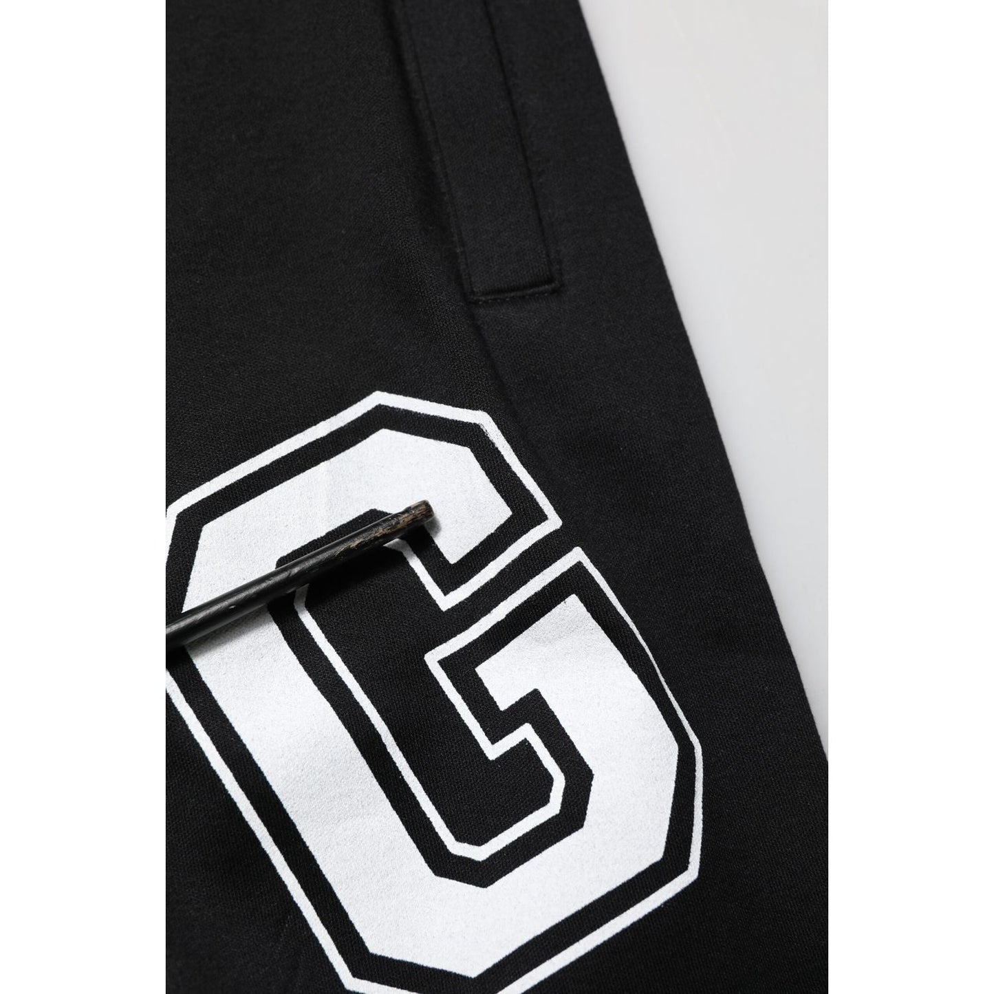 Close-up of Dolce & Gabbana Black Logo Print Cotton Casual Bermuda Short showing logo and drawstring detail.