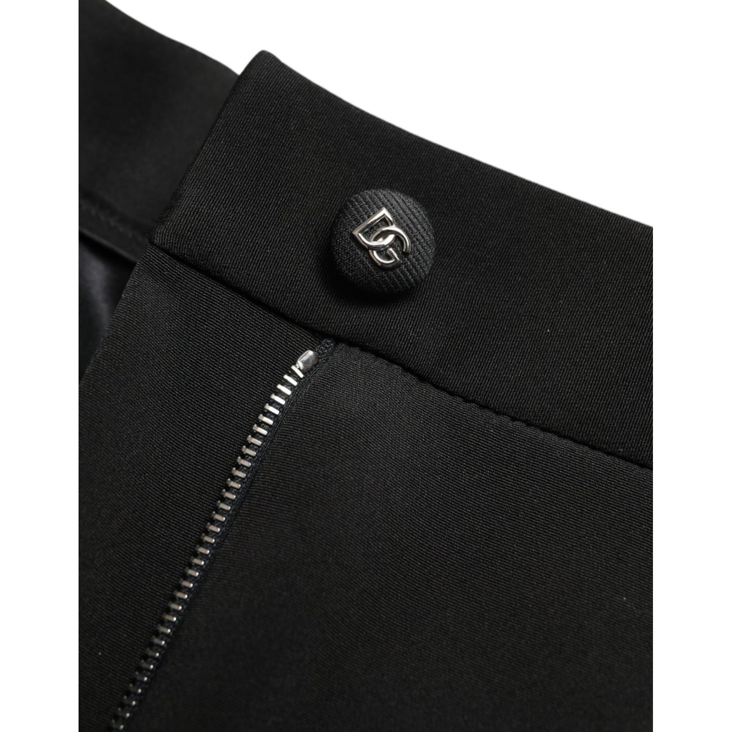 Close-up of Dolce & Gabbana Black Wool Stretch High Waist Skinny Pants with zipper and logo button detail.