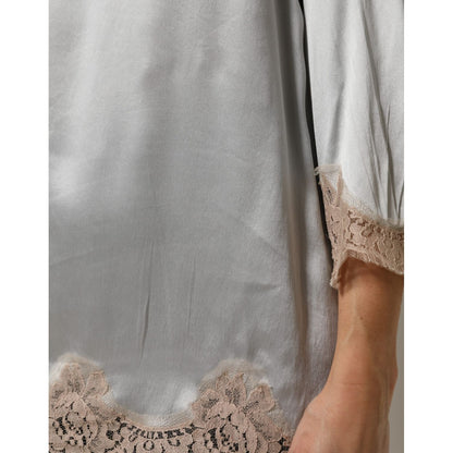 Close-up of Dolce & Gabbana Gray Silk Satin Floral Lace Long Sleeve Top with delicate lace detailing on sleeve and hem.