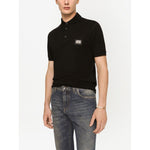 Dolce & Gabbana Logo cotton polo shirt in black with silver-tone logo plaque, piqué weave, polo collar, front button placket, short sleeves.