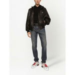 Model wearing a Dolce & Gabbana Logo cotton polo shirt with black jacket and denim jeans