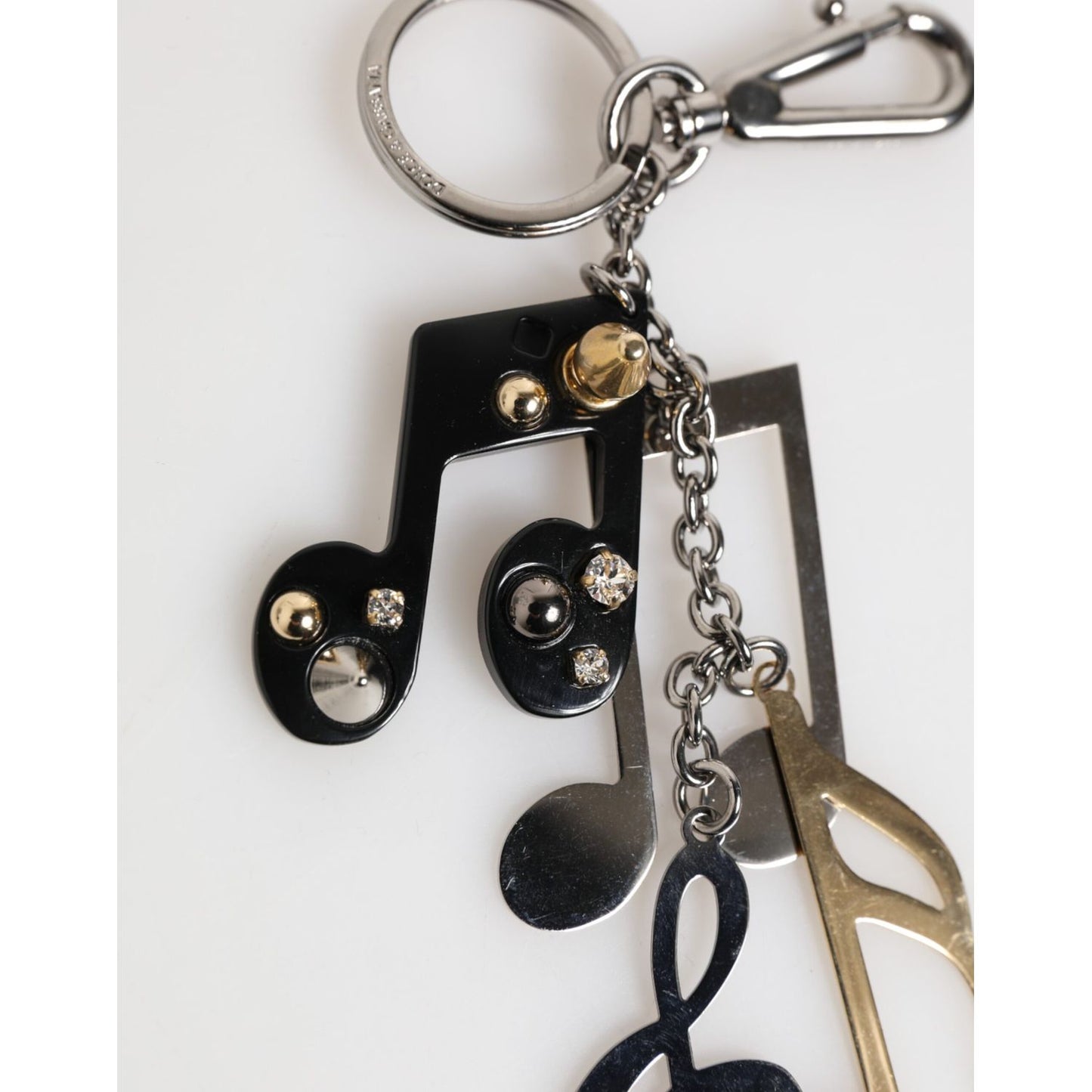 Dolce & Gabbana Silver Musical Note Key Holder Keychain Bag Charm Keyring with shiny finish and logo engraving.
