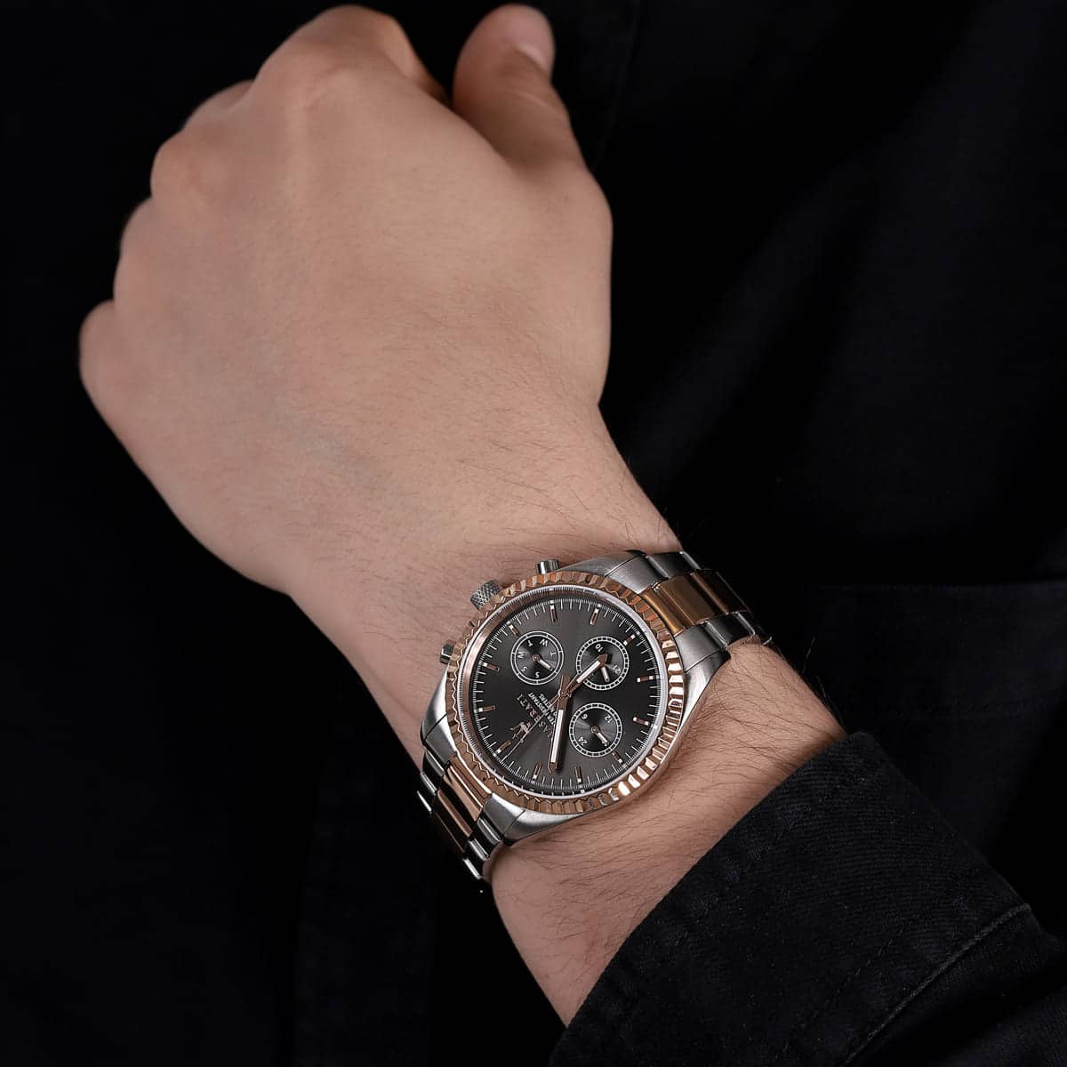 MASERATI MOD. R8853100020 wristwatch with rose gold two-tone stainless steel strap and black multifunction dial worn on wrist.