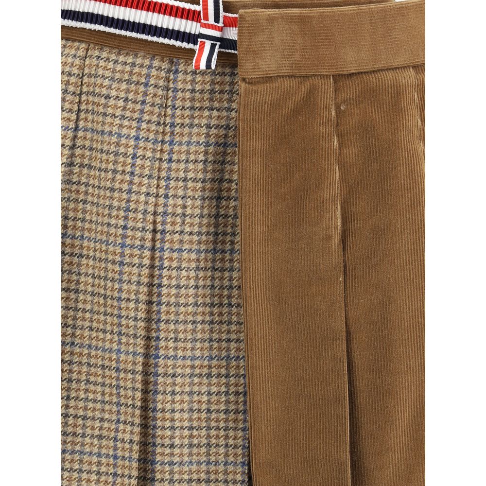 Close-up of Thom Browne Brown Wool Mini Skirt with pleated velvet and houndstooth design, striped side band, and side pockets.