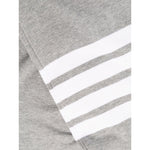 Close-up of Thom Browne Trousers Grey featuring the signature 4-Bar stripe design and cotton fabric details.