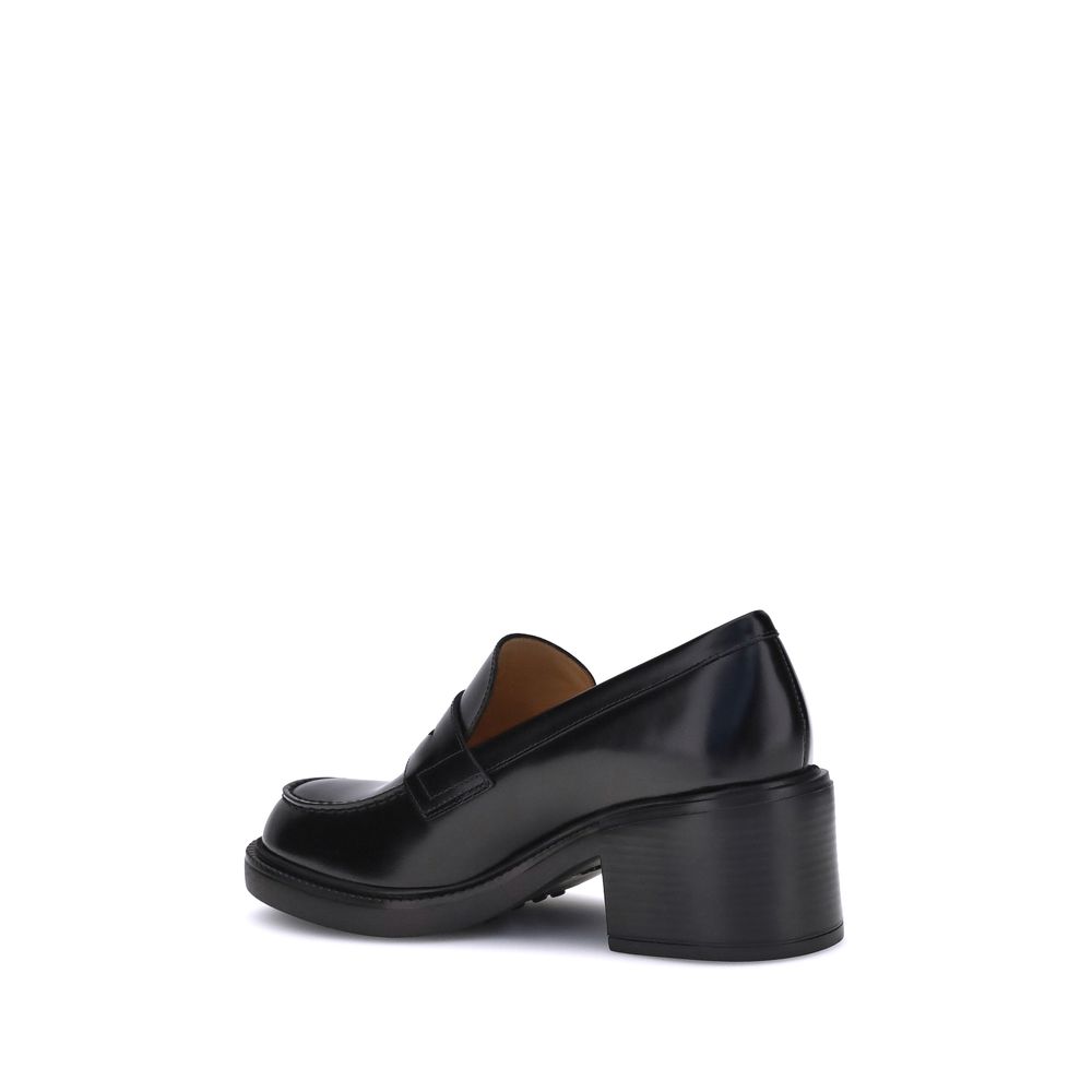 "Side view of Tod's Black Calf Leather Bos Taurus Platform Loafers with chunky heel, elegant and versatile design, made in Italy."