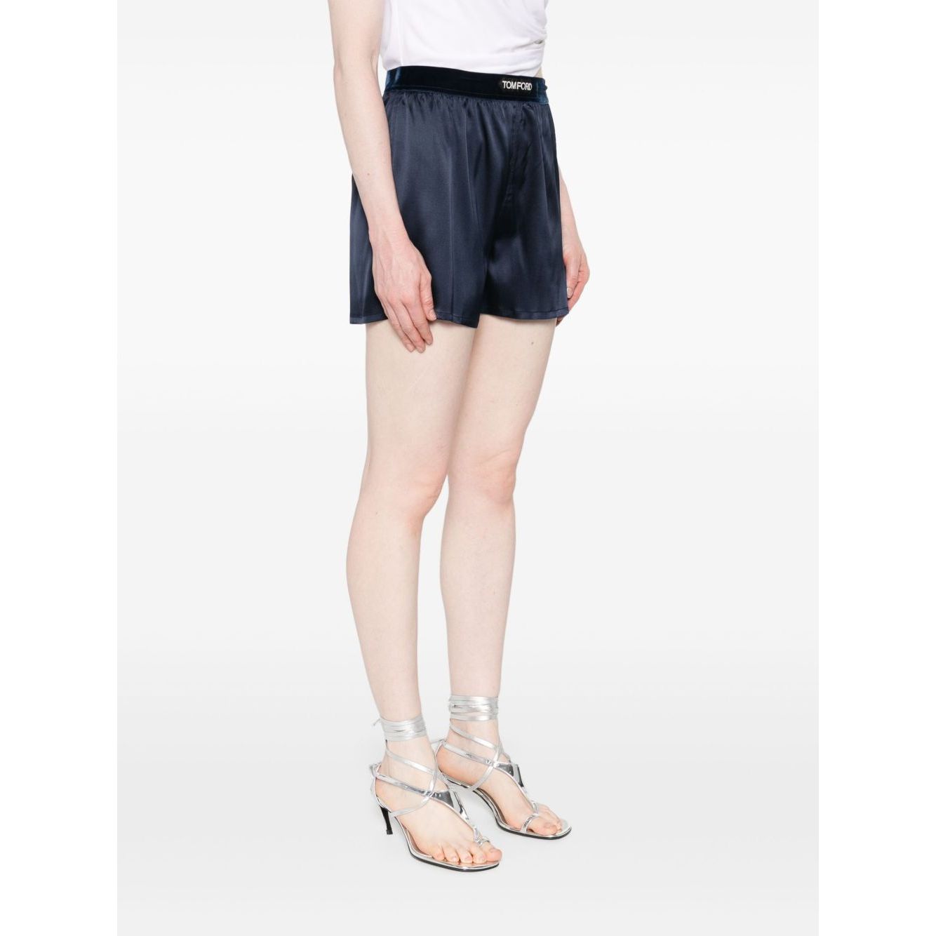 Tom Ford Shorts Blue featuring navy blue silk, elasticated logo waistband, worn by model, true to size fit, fashionable for summer.