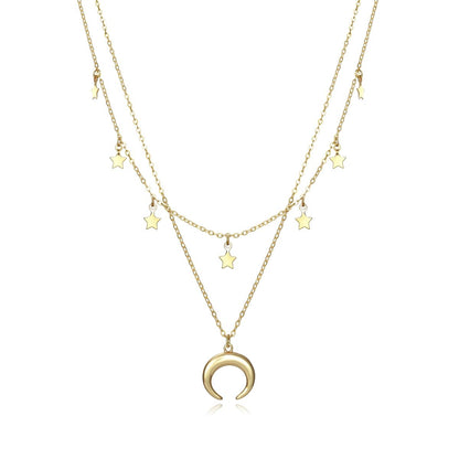 Gold layered necklace with star and crescent moon charms displayed on white background.