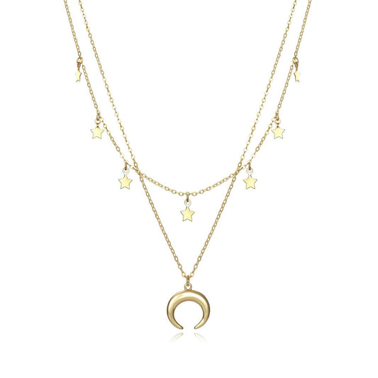 Gold layered necklace with star and crescent moon charms displayed on white background.