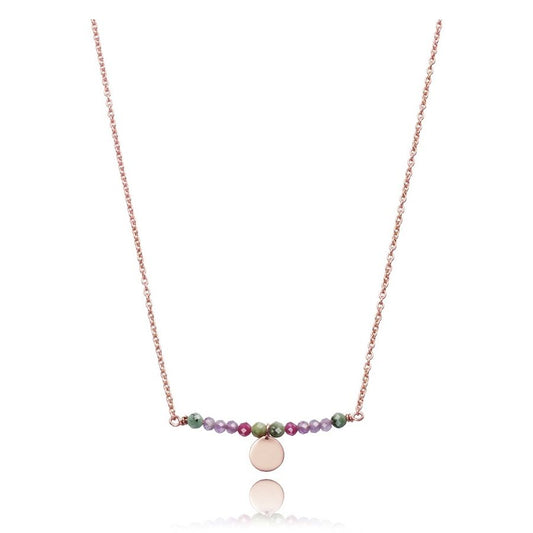 Elegant necklace with mixed beads and a round charm, displayed against a white background