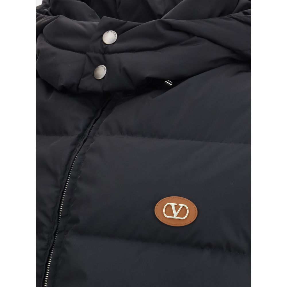 Valentino Black Goose Down Sleveless Jacket with leather logo patch, featuring padded design and removable hood. Made in Italy.