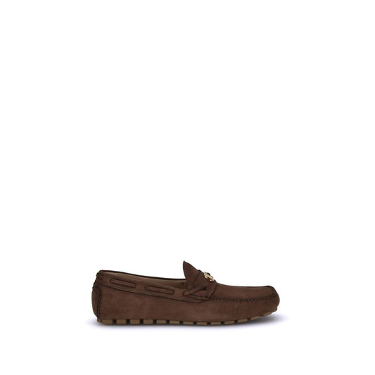 Valentino Garavani Brown Rubber Slip-On Loafers with VLogo plaque and notched sole, showcasing sleek suede design and comfort.