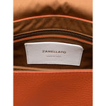 Interior of Zanellato Postina Daily Small leather handbag with logo tag showing "Made in Italy".